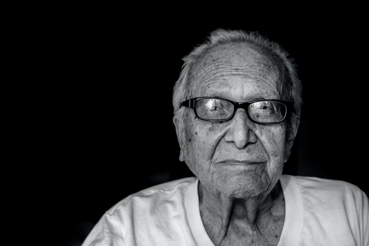 grey photo of an older man wearing glasses